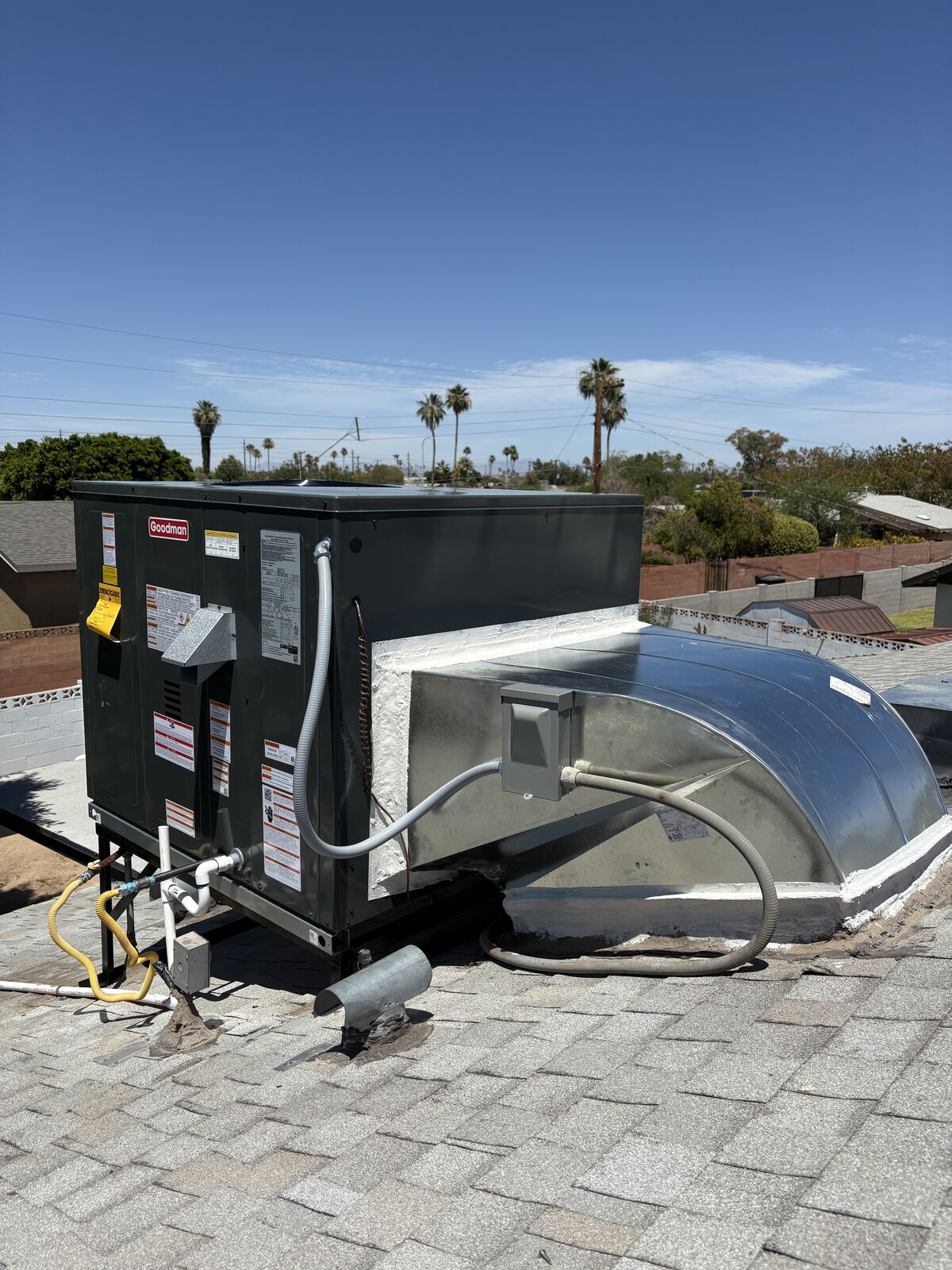 New rooftop HVAC package unit with fresh ductwork transition, overlooking the East Valley skyline